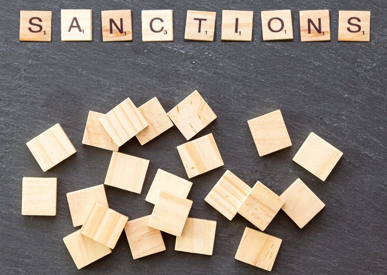 Image of letters spelling "sanctions" in a game of scrabble